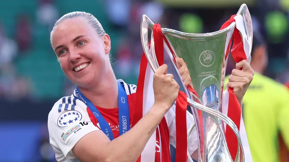 Arsenal forward Beth Mead holding the Women's Champions League trophy